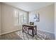 Home office with wood desk, chair, and neutral-toned wall art at 3601 Arapahoe Ave # 102, Boulder, CO 80303