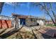 The backyard features a brick patio, blue doors, and a partial overhang at 1720 Pecos Way, Denver, CO 80221