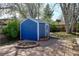 This backyard features a fire pit, a shed, and a brick patio at 1720 Pecos Way, Denver, CO 80221