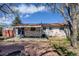 The backyard features a brick patio and exterior access to the home at 1720 Pecos Way, Denver, CO 80221