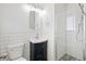 Bathroom featuring a glass-enclosed shower, a dark vanity and subway tile at 1720 Pecos Way, Denver, CO 80221