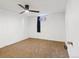 The bedroom has simple decor with a fan and a large window at 1720 Pecos Way, Denver, CO 80221