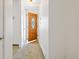 Inviting entryway featuring a decorative front door and neutral carpet at 1720 Pecos Way, Denver, CO 80221
