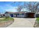 Attractive home featuring a covered parking area, classic brick, and well-kept landscaping at 1720 Pecos Way, Denver, CO 80221