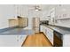Bright kitchen with stainless steel appliances, ample cabinetry, and wood floors at 1720 Pecos Way, Denver, CO 80221
