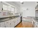 Spacious kitchen with stainless steel appliances, wood floor and bright breakfast nook at 1720 Pecos Way, Denver, CO 80221
