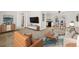 Open-concept living area flowing into the kitchen and dining space at 1720 Pecos Way, Denver, CO 80221