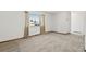 Bright room with neutral carpet and a large window at 1720 Pecos Way, Denver, CO 80221