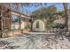 Private backyard with a greenhouse, mature trees, and stone landscaping, creating a serene outdoor space at 1928 S Washington St, Denver, CO 80210