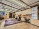 Basement featuring hardwood floors, built-in shelves, cabinets, and a comfortable workspace at 1928 S Washington St, Denver, CO 80210