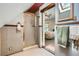 Bathroom boasts a glass-enclosed shower, wood trim, and access to a bedroom, offering convenience and style at 1928 S Washington St, Denver, CO 80210