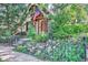 Charming cottage-style home with landscaped front yard and American flag flying at the entrance at 1928 S Washington St, Denver, CO 80210