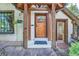 Inviting front entrance with wooden door, stone steps, and well-maintained landscaping at 1928 S Washington St, Denver, CO 80210