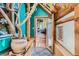 Hallway with slate flooring, natural light, wood detailing, and indoor greenery at 1928 S Washington St, Denver, CO 80210