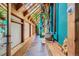 Hallway with slate flooring, natural light, wood detailing, and indoor greenery at 1928 S Washington St, Denver, CO 80210