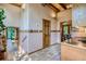 Hallway with tile flooring and wood trim, leading to multiple rooms and featuring ample natural light at 1928 S Washington St, Denver, CO 80210