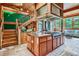 Gourmet kitchen featuring a center island, high-end appliances, and adjacent staircase at 1928 S Washington St, Denver, CO 80210