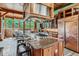 Chef's kitchen with a large island, granite countertops, and abundant natural light at 1928 S Washington St, Denver, CO 80210