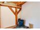 Cozy living room featuring a decorative blue wood burning stove, wood beam and hardwood floors at 1928 S Washington St, Denver, CO 80210