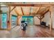 Spacious living room with wood beams, hardwood floors, plenty of windows, and a cozy fireplace at 1928 S Washington St, Denver, CO 80210