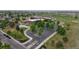 Aerial view of a neighborhood with green spaces, tree-lined streets, and well-maintained townhomes at 9758 Laredo St # 22D, Commerce City, CO 80022
