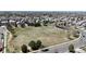 An aerial view of a large grassy park provides open space for community activities and leisure, surrounded by residential homes at 9758 Laredo St # 22D, Commerce City, CO 80022