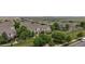 Picturesque aerial view features lovely townhomes, mature trees, and an expansive green space at 9758 Laredo St # 22D, Commerce City, CO 80022