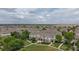 Aerial view of modern townhomes with sidewalks and green space in a Gathering-friendly neighborhood at 9758 Laredo St # 22D, Commerce City, CO 80022