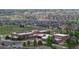 An aerial view showcases a school building, playground, and the surrounding community at 9758 Laredo St # 22D, Commerce City, CO 80022