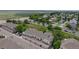 Aerial view highlighting the community's layout, garages, nearby landscaping, and street access at 9758 Laredo St # 22D, Commerce City, CO 80022
