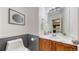 Bathroom featuring a toilet, sink, cabinet, framed art and neutral paint at 9758 Laredo St # 22D, Commerce City, CO 80022