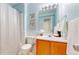 Freshly painted blue bathroom with updated vanity, commode, and shower at 9758 Laredo St # 22D, Commerce City, CO 80022