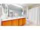 Bathroom featuring tile floors, double sinks and plenty of counter space and storage at 9758 Laredo St # 22D, Commerce City, CO 80022