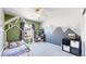 Colorful room with a unique play bed, mountain mural, and comfortable carpet at 9758 Laredo St # 22D, Commerce City, CO 80022