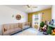 Bright, cozy bedroom featuring two wooden cribs, colorful decor, and a ceiling fan for a comfortable atmosphere at 9758 Laredo St # 22D, Commerce City, CO 80022