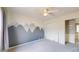 Bright bedroom featuring a lovely gray mountain mural and closet at 9758 Laredo St # 22D, Commerce City, CO 80022