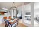 Inviting dining space open to living area featuring stylish lighting and hardwood floors at 9758 Laredo St # 22D, Commerce City, CO 80022