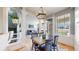 Open dining area connects living spaces, featuring a modern light fixture and seating at 9758 Laredo St # 22D, Commerce City, CO 80022