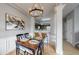 Cozy dining room with elegant chandelier, seamlessly flowing into the adjacent kitchen at 9758 Laredo St # 22D, Commerce City, CO 80022
