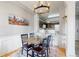 Elegant dining area with stylish chandelier, seating for four, and easy kitchen access at 9758 Laredo St # 22D, Commerce City, CO 80022