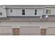 Attached garages with stone accents and neutral doors provide convenience and curb appeal at 9758 Laredo St # 22D, Commerce City, CO 80022