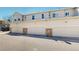 Attached garages with stone accents for a stylish and functional townhome exterior at 9758 Laredo St # 22D, Commerce City, CO 80022