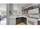 Modern kitchen featuring white appliances, backsplash, and dark wood cabinetry at 9758 Laredo St # 22D, Commerce City, CO 80022