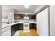 Bright kitchen with white appliances, stylish cabinets, and hardwood flooring at 9758 Laredo St # 22D, Commerce City, CO 80022