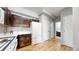 Charming kitchen featuring dark wood cabinets, stone backsplash, and hardwood floors at 9758 Laredo St # 22D, Commerce City, CO 80022