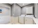 Efficient laundry room featuring a white washer, dryer, overhead storage, and easy access at 9758 Laredo St # 22D, Commerce City, CO 80022