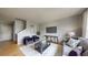 Bright living room with hardwood floors, two armchairs, and a comfortable gray sofa at 9758 Laredo St # 22D, Commerce City, CO 80022