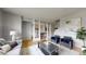 Spacious living area with hardwood floors, cozy seating, and bright natural light streaming through windows at 9758 Laredo St # 22D, Commerce City, CO 80022