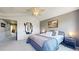 Well-lit main bedroom with ensuite access, decorative mirror and mountain picture on the wall at 9758 Laredo St # 22D, Commerce City, CO 80022