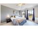 Primary bedroom with large windows, ceiling fan, and contemporary decor at 9758 Laredo St # 22D, Commerce City, CO 80022